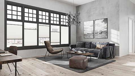 Graues Wohnzimmer mit MHZ Duette® Wabenplissee „Angelhair 8222“ an grossen Sprossenfenstern.